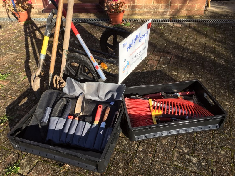Gardening tools organised in crates and tool rool